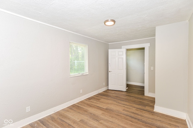 1115 N Keystone Ave, Indianapolis, IN 46201 - empty room with ornamental molding, baseboards, wood finished floors, and a textured ceiling