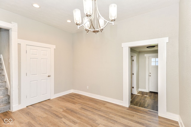 1115 N Keystone Ave, Indianapolis, IN 46201 - spare room with a chandelier, light wood-style floors, recessed lighting, stairway, and baseboards