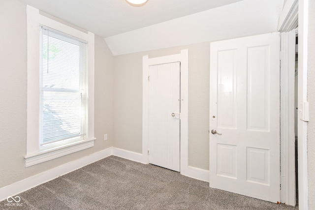 1115 N Keystone Ave, Indianapolis, IN 46201 - unfurnished bedroom featuring carpet, vaulted ceiling, and baseboards