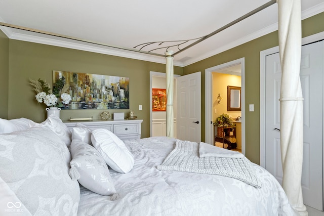 bedroom featuring ornamental molding and ensuite bathroom