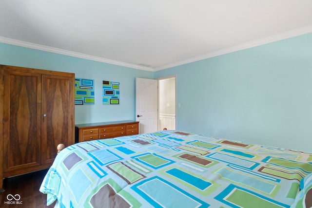 bedroom with ornamental molding and dark wood finished floors