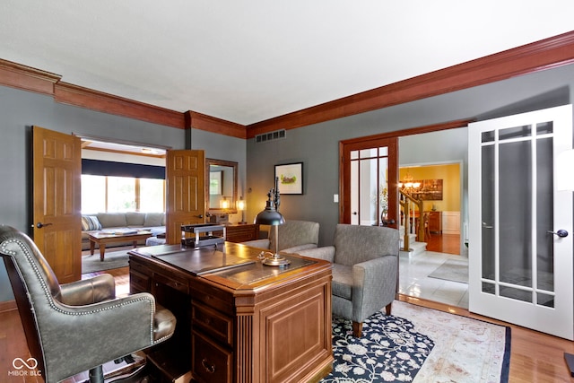 office area with ornamental molding, a chandelier, and light wood finished floors