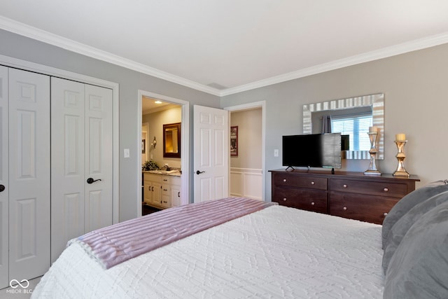 bedroom with ornamental molding, a closet, and connected bathroom