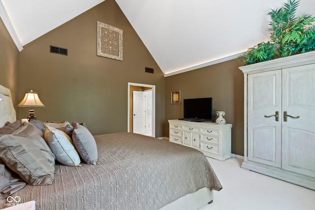 bedroom featuring light colored carpet and high vaulted ceiling