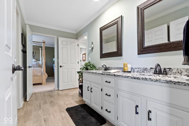 bathroom with crown molding, ensuite bathroom, double vanity, and wood finished floors
