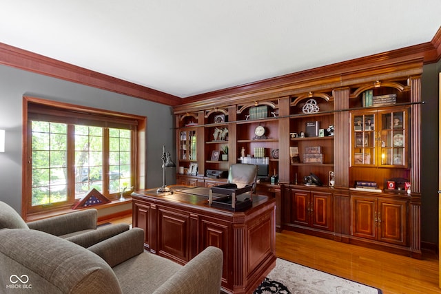 office area with crown molding and light wood-style flooring