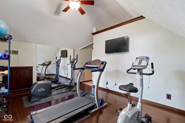 workout room featuring vaulted ceiling, ceiling fan, wood finished floors, and baseboards