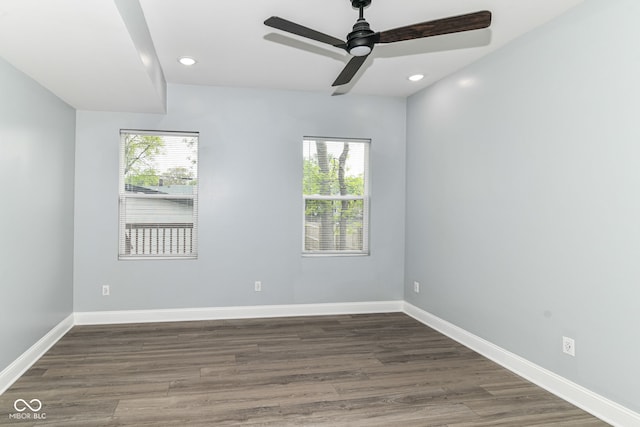 spare room featuring plenty of natural light, ceiling fan, wood finished floors, baseboards, and recessed lighting