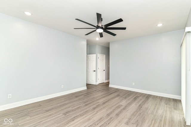 empty room with a ceiling fan, light wood finished floors, recessed lighting, and baseboards