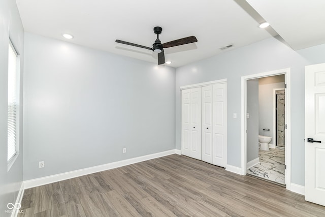 unfurnished bedroom with wood finished floors, baseboards, a closet, recessed lighting, and ceiling fan