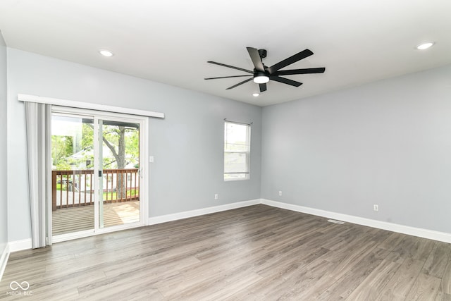 spare room featuring wood finished floors, ceiling fan, healthy amount of natural light, baseboards, and recessed lighting