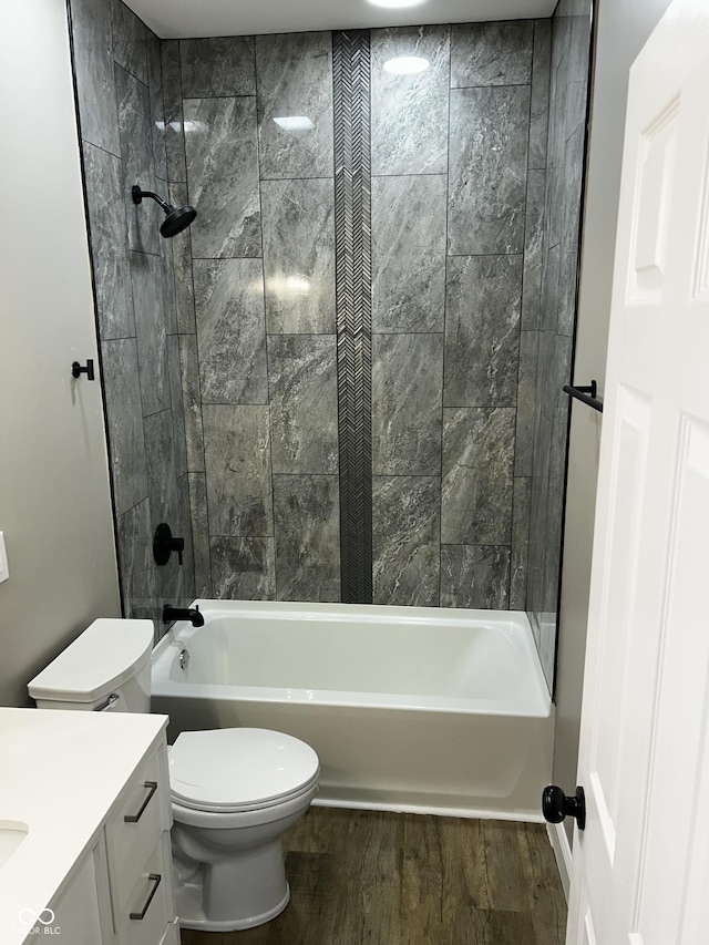 336 W 29th St, Indianapolis, IN 46208 - bathroom with wood finished floors, toilet, vanity, and tub / shower combination