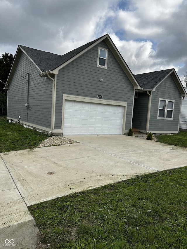 336 W 29th St, Indianapolis, IN 46208 - view of front of home featuring concrete driveway, a garage, a shingled roof, and a front lawn