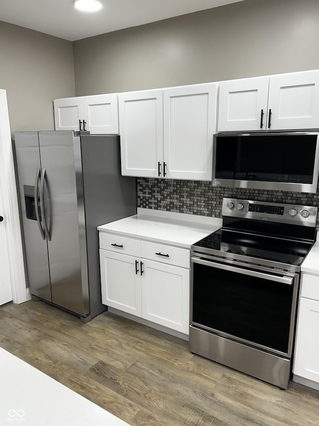 336 W 29th St, Indianapolis, IN 46208 - kitchen with stainless steel appliances, white cabinets, light countertops, and tasteful backsplash