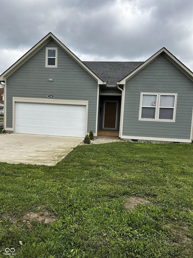 336 W 29th St, Indianapolis, IN 46208 - view of front of home with roof with shingles, a front lawn, driveway, and a garage