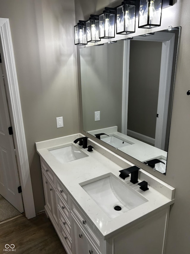 336 W 29th St, Indianapolis, IN 46208 - bathroom featuring wood finished floors and double vanity