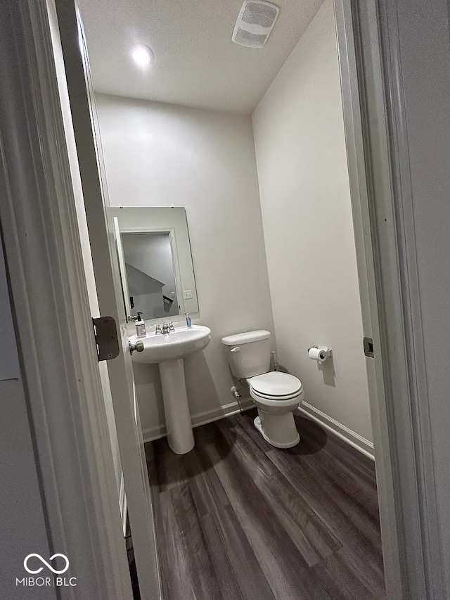 13460 Dewpoint Ln, Fishers, IN 46037 - half bath with toilet, wood finished floors, baseboards, and a sink