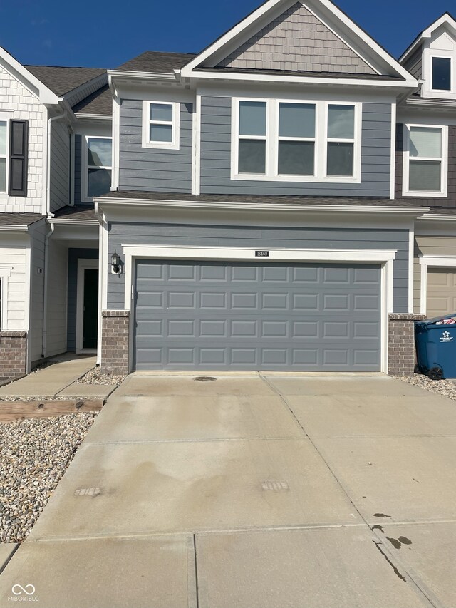 13460 Dewpoint Ln, Fishers, IN 46037 - view of front facade with an attached garage, brick siding, and concrete driveway