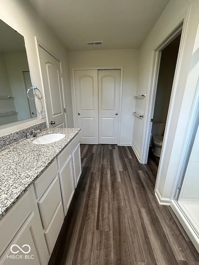13460 Dewpoint Ln, Fishers, IN 46037 - bathroom featuring wood finished floors, toilet, and vanity