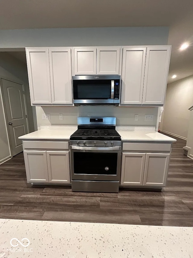 13460 Dewpoint Ln, Fishers, IN 46037 - kitchen featuring appliances with stainless steel finishes, light countertops, dark wood-style floors, and recessed lighting