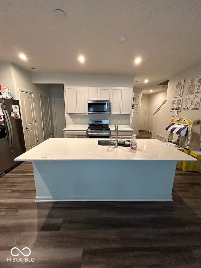 13460 Dewpoint Ln, Fishers, IN 46037 - kitchen featuring appliances with stainless steel finishes, dark wood-type flooring, a sink, white cabinets, and recessed lighting