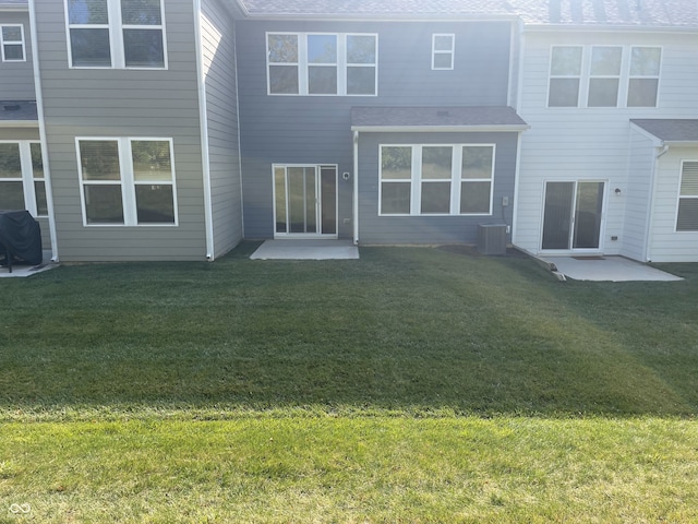 13460 Dewpoint Ln, Fishers, IN 46037 - rear view of property featuring a yard, a patio area, central air condition unit, and a shingled roof