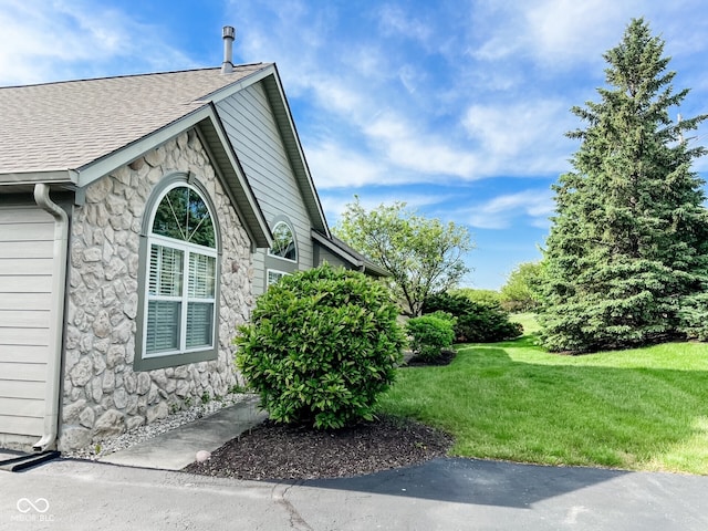 16657 Brownstone Ct, Westfield, IN 46074 - view of side of home with stone siding, a yard, and a shingled roof