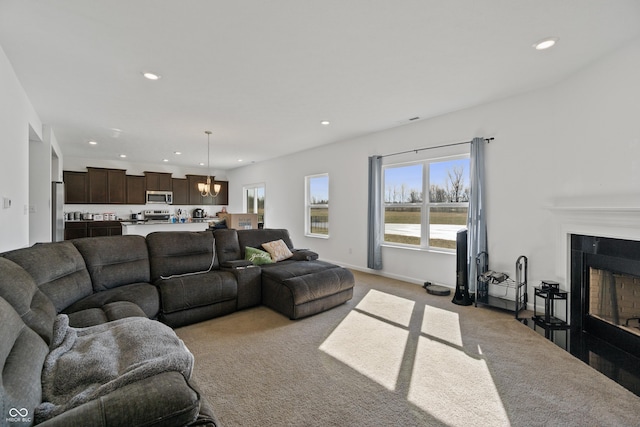 6903 Aster Dr, Pendleton, IN 46064 - living room with light colored carpet, recessed lighting, healthy amount of natural light, a tile fireplace, and baseboards