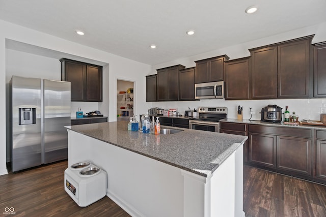 6903 Aster Dr, Pendleton, IN 46064 - kitchen with appliances with stainless steel finishes, a sink, dark stone countertops, dark wood-type flooring, and dark brown cabinets