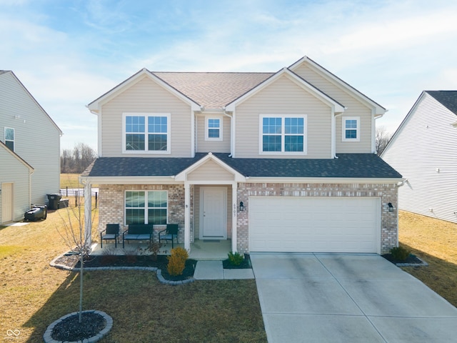 6903 Aster Dr, Pendleton, IN 46064 - view of front facade with covered porch, brick siding, concrete driveway, an attached garage, and a front yard