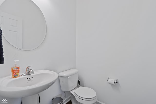 6903 Aster Dr, Pendleton, IN 46064 - half bathroom featuring toilet, a sink, and baseboards