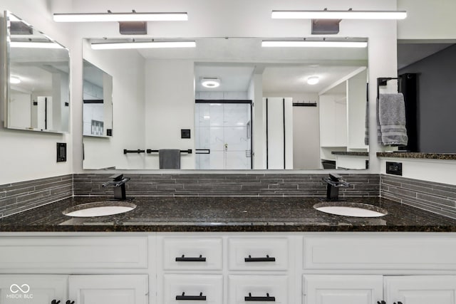 full bath featuring a stall shower and double vanity