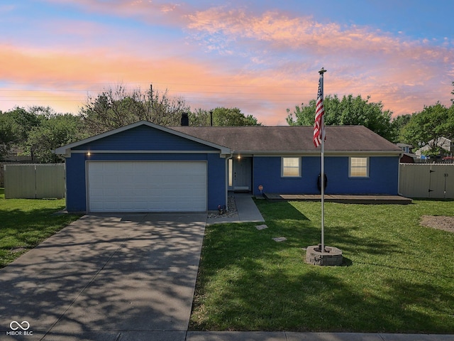single story home with concrete driveway and a garage