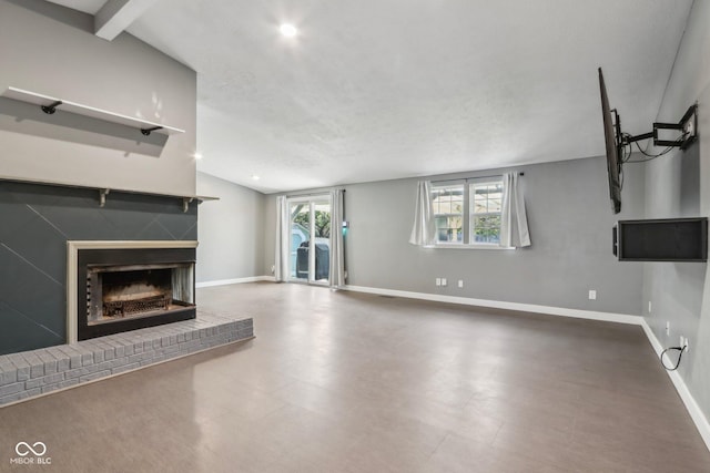 unfurnished living room featuring a fireplace, vaulted ceiling, and baseboards