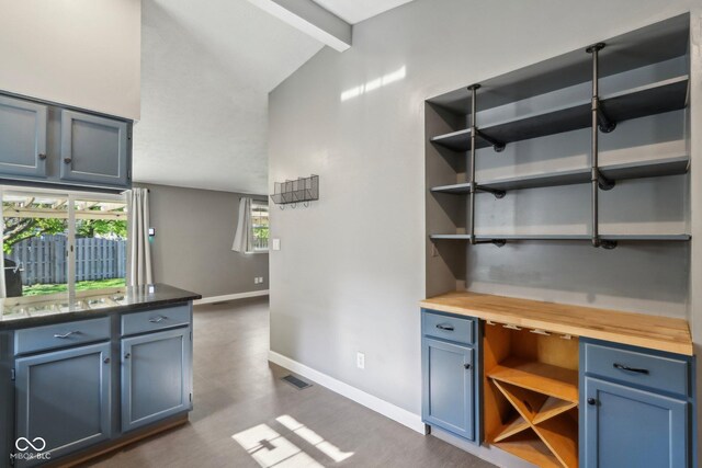 unfurnished office with baseboards, healthy amount of natural light, and dark wood-type flooring