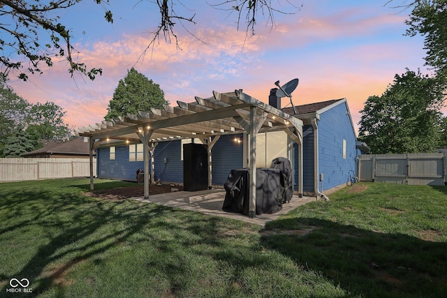 back of property at dusk with a pergola, a gate, a patio, and a chimney