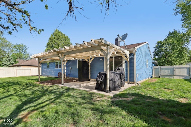 back of house featuring a pergola, a gate, a chimney, and a patio area