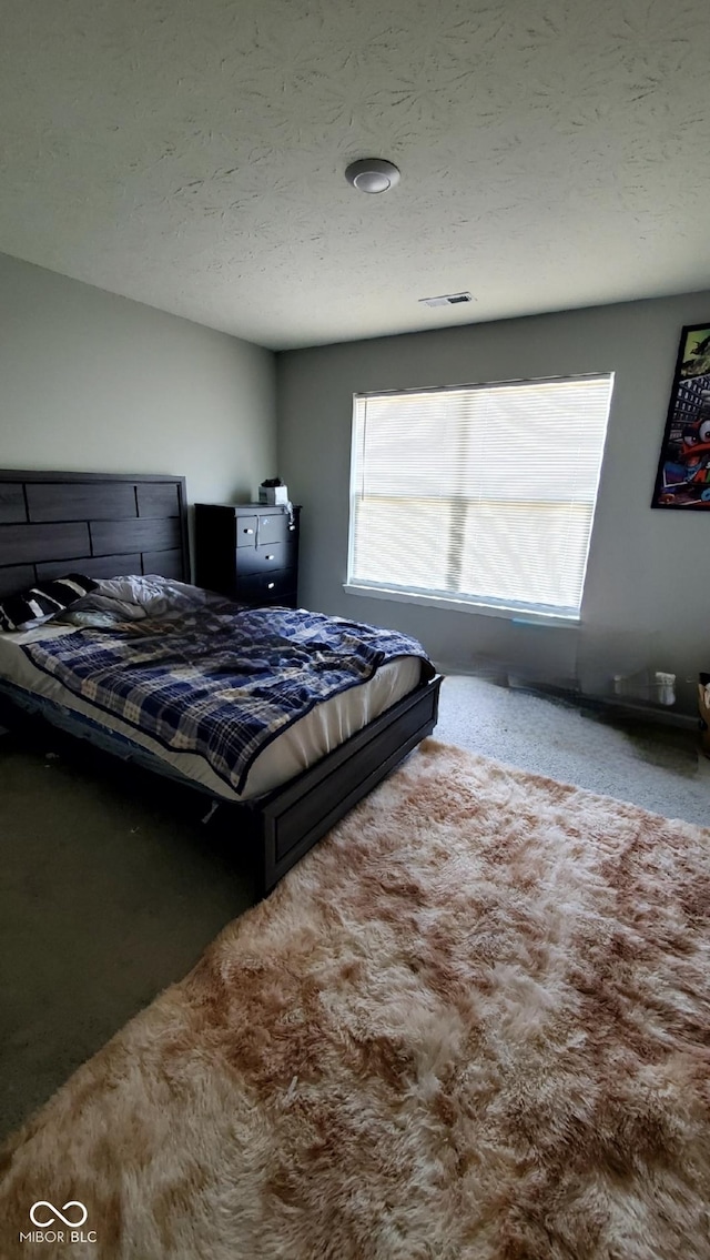 carpeted bedroom with a textured ceiling