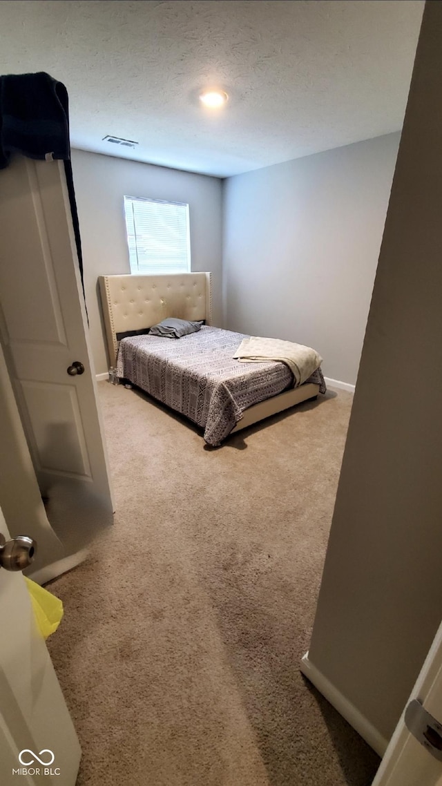 bedroom with carpet floors and baseboards