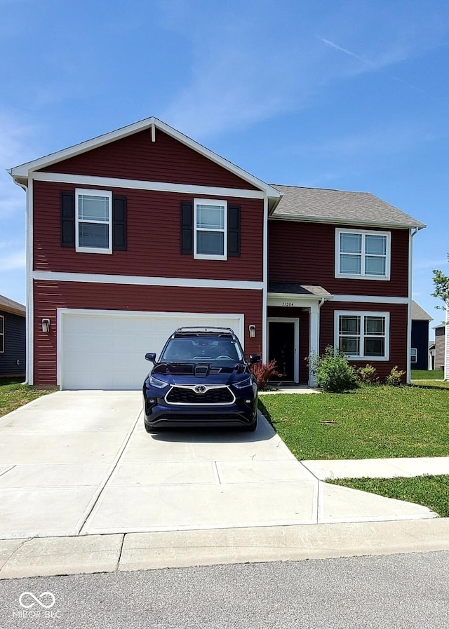 view of front of property featuring an attached garage, driveway, and a front yard