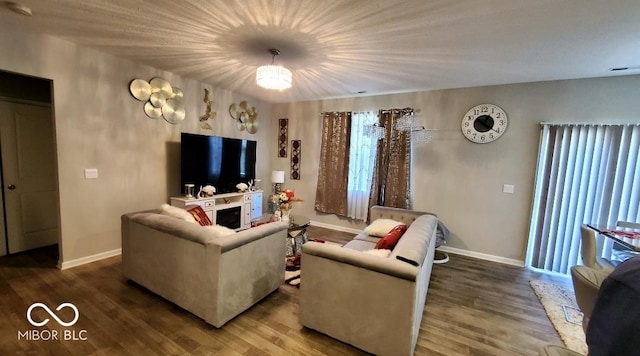 living room featuring baseboards and wood finished floors