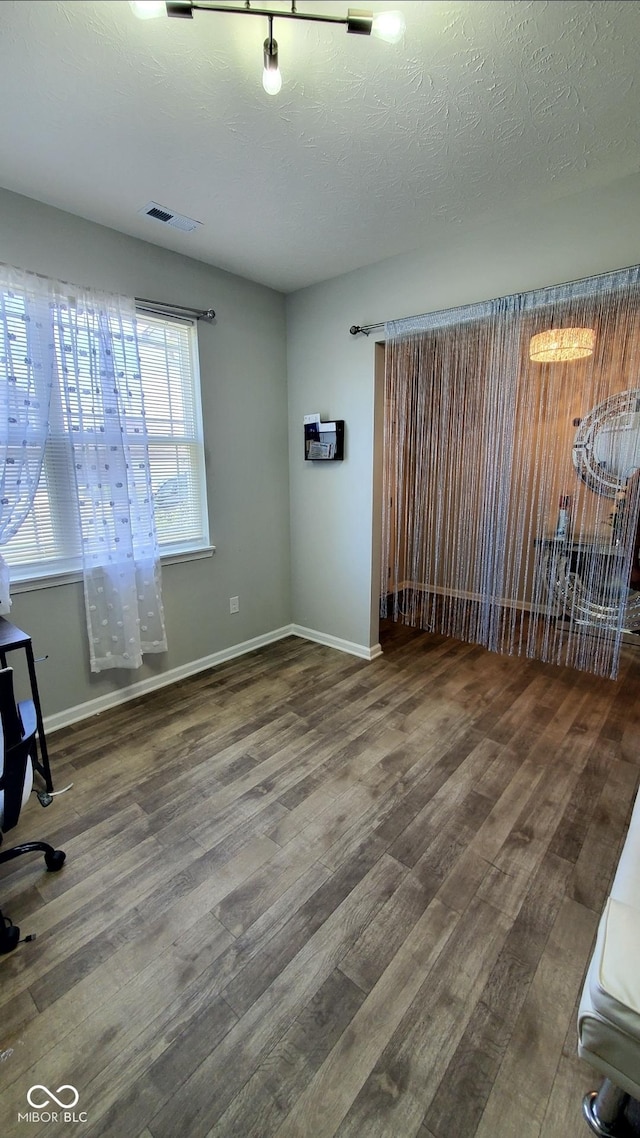 unfurnished room featuring wood finished floors and baseboards