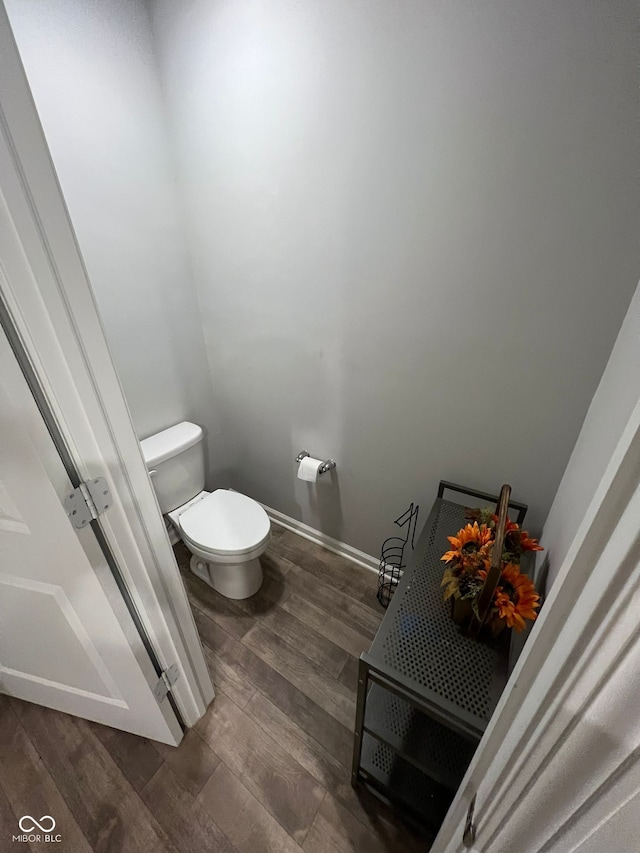 bathroom featuring wood finished floors and toilet