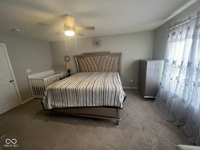 bedroom with carpet flooring, a ceiling fan, a textured ceiling, and baseboards