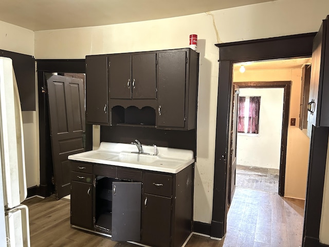 205 N Sheffield Ave, Indianapolis, IN 46222 - kitchen with freestanding refrigerator, wood finished floors, light countertops, and a sink
