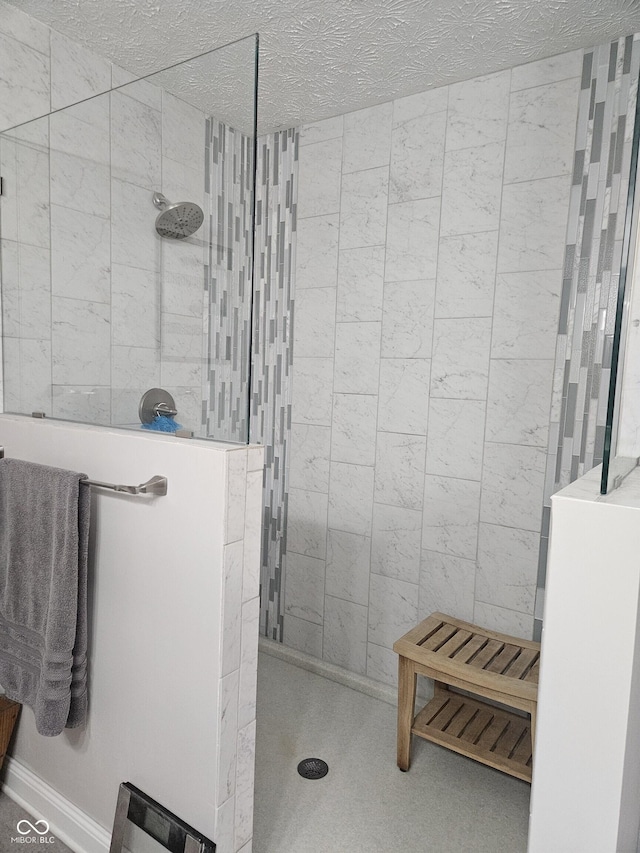 bathroom featuring walk in shower and a textured ceiling