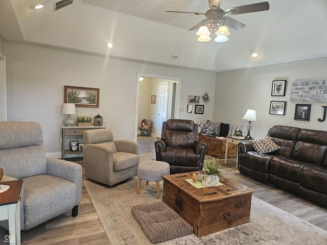 living area with wood finished floors, ceiling fan, lofted ceiling, and recessed lighting