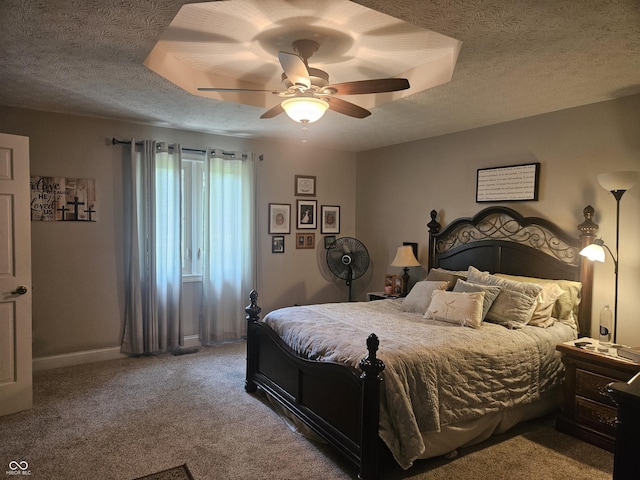 carpeted bedroom featuring a textured ceiling, baseboards, and ceiling fan