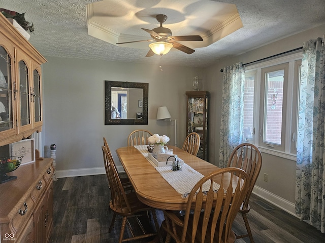 dining room with baseboards, dark wood-style floors, a textured ceiling, and ceiling fan