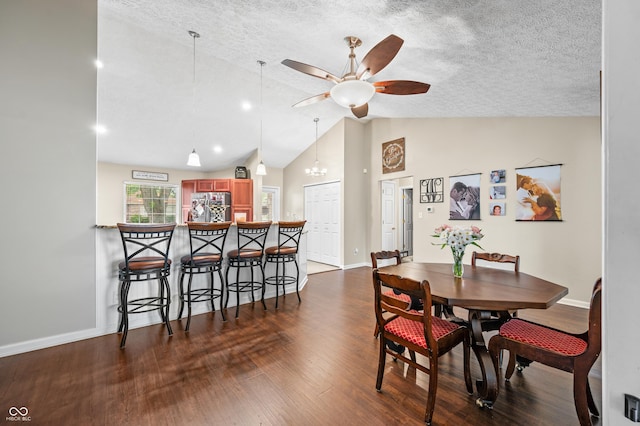 dining room featuring vaulted ceiling, ceiling fan, dark wood finished floors, baseboards, and a textured ceiling